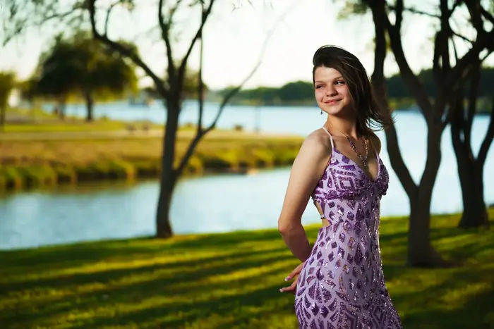 Outdoor senior portrait of a girl in a purple dress in Carlsbad NM